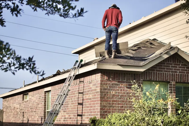 Professional roofer working on a residential roof in Storey Park